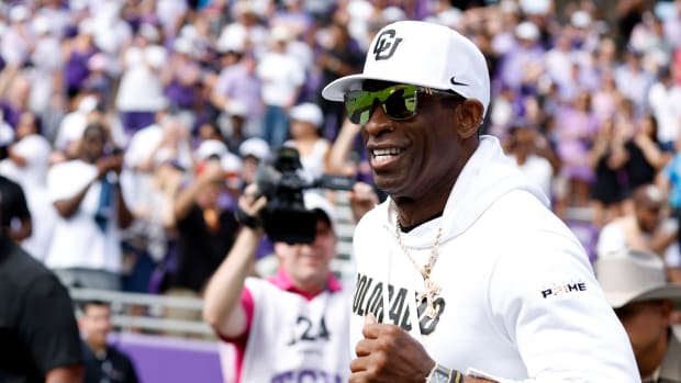 Colorado Buffaloes head coach Deon Sanders runs on the field before the game against the TCU Horned Frogs at Amon G. Carter Stadium